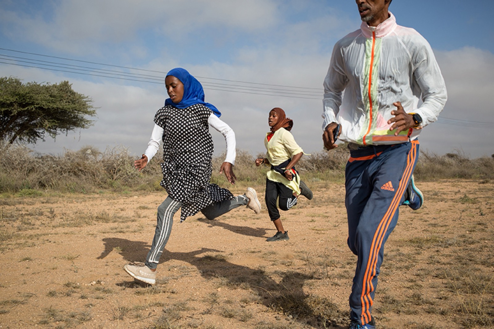 NYT, photo 05. Hanna and Hamda train with their coach, Abdirashid.